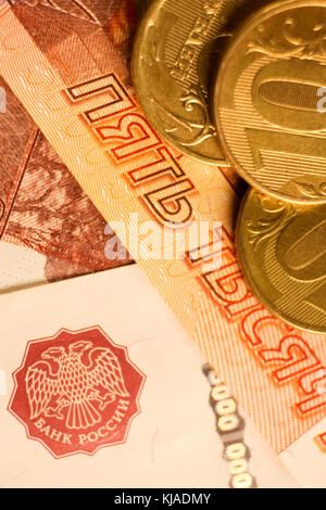 Set of russian ruble coins laying on russian banknotes. Russian currency close up. Financial concept. Stock Photo