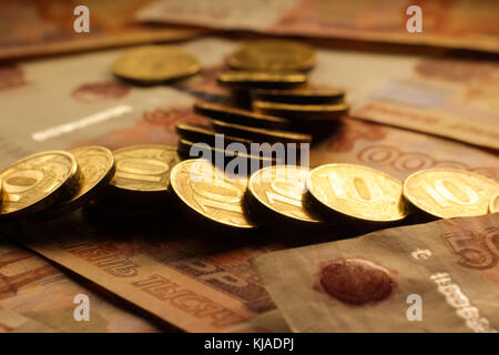 Set of russian ruble coins laying on russian banknotes. Russian currency close up. Financial concept. Stock Photo