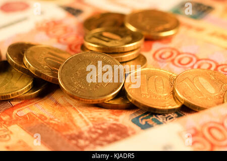 Set of russian ruble coins laying on russian banknotes. Russian currency close up. Financial concept. Stock Photo