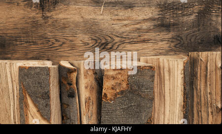 Pile of beech fire wood with the view from above, space for text on wooden wall Stock Photo