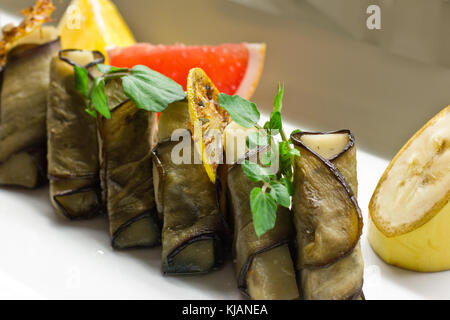 Stuffed eggplant with the greens, grapefruit, lemon and banana slices Stock Photo