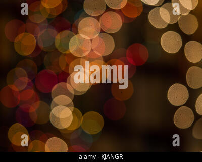 Blurred colorful Christmas lights background over dark background with library. Abstraction. Stock Photo