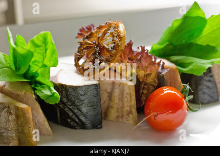 Hot smoked mackerel. Sliced with the herbs and cherry tomatoes Stock Photo