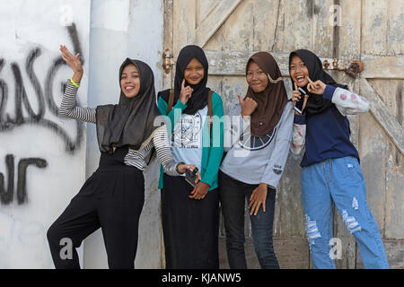 Happy modern dressed young Indonesian girls wearing jilbab / hijab, Semarang, Java, Indonesia Stock Photo