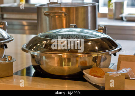 Large metal saucepan on the gas fire Stock Photo