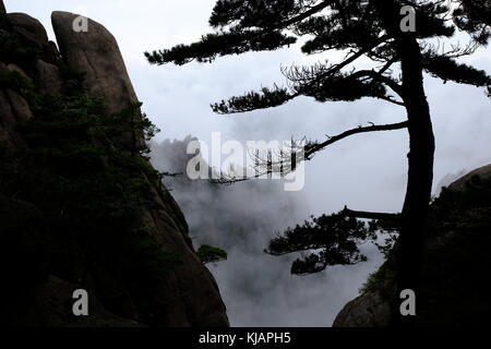 Cloud covered rugged peaks of Huangshan mountains in China Stock Photo