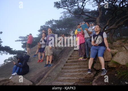 Tourists watching sunset at the famous Huangshan mountains in China, in Anhui province Stock Photo
