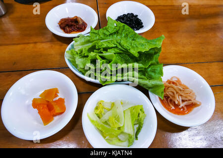 Kimchi, fermented Korean side dish made of vegetables with a variety of seasonings, traditional of Korean food. Stock Photo