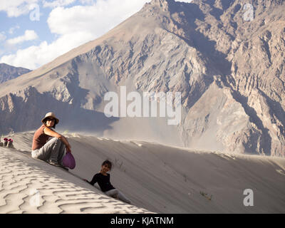 children having fun at the sand dunes - Nubra valley Ladakh India Stock Photo