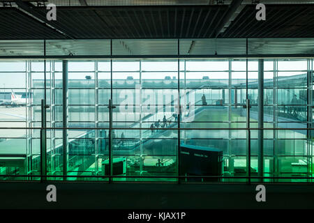 Passengers walk through the terminal at Paris Charles de Gaulle, aka Roissy, Airport in France. Stock Photo