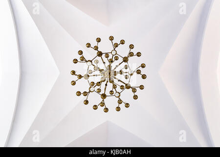 Chandelier on a church ceiling.Symmetry, lines and circles. Stock Photo