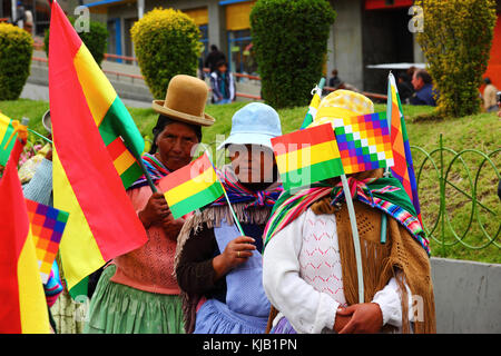 Bolivian women in colorful traditional costumes marching during the ...