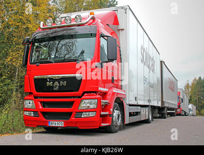 KOSKI, FINLAND - OCTOBER 5, 2013: Red MAN TGS18.360 truck and full trailer parked. MAN presents The MAN Trucknology Days 2015 in 19-21 March in Munich Stock Photo