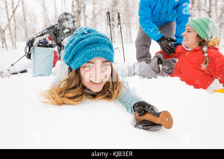 Portrait of smiling Caucasian girl falling in snow Stock Photo