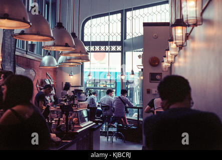 People enjoying coffee in a busy cafe in Montreal, Canada Stock Photo