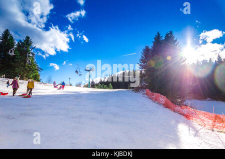 Family have fun with ski vehicles at Pertouli ski center, trikala, Greece on December 27, 2016. Stock Photo