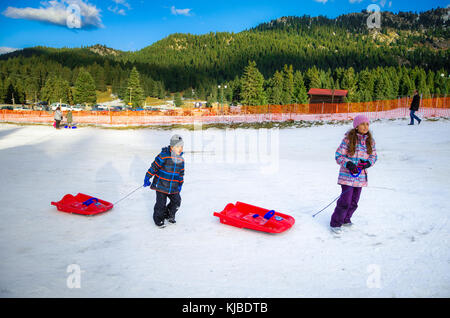 Family have fun with ski vehicles at Pertouli ski center, trikala, Greece on December 27, 2016. Stock Photo