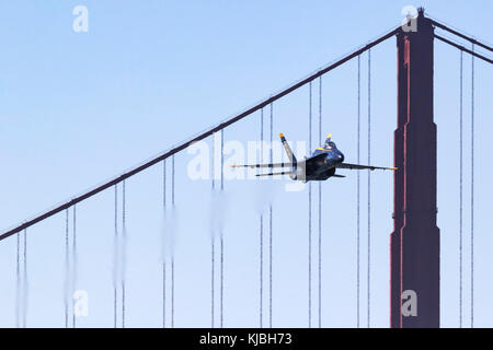 Blue Angels 5, the lead solo, approaches the airshow box from out of the west and over the Golden Gate Bridge Stock Photo
