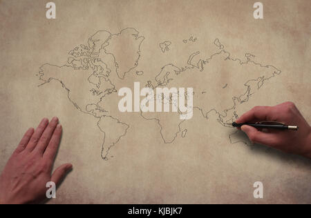 Hands drawing world map. Outline world map on the old paper texture background. Hands drawing contour of global map with pencil. Stock Photo