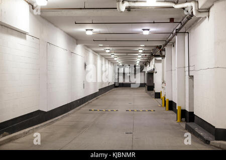 Parking garage driveway illuminated at night Stock Photo