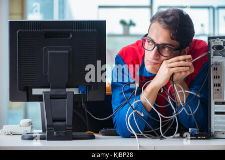 Computer repairman working on repairing computer in IT workshop Stock Photo