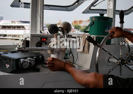 The pilot of a public ferry boat on the Chao Praya river in Bangkok, Thailand. Stock Photo