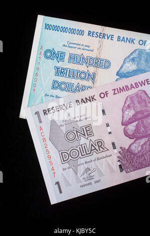 Hyperinflation - 100 Trillion Dollar Zimbabwe banknote (2008) & 2007 1 Dollar bill. Metaphor for Hyperinflation, worthless money & Zimbabwe's economy Stock Photo