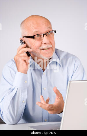 Man with Cellular Phone and Laptop Computer Stock Photo