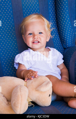 Toddler with Teddy Bear in Armchair Stock Photo - Alamy