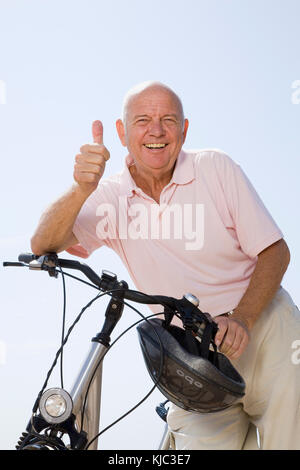 Man with Bicycle Giving Thumbs Up Stock Photo