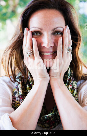 Woman Touching Cheeks Stock Photo