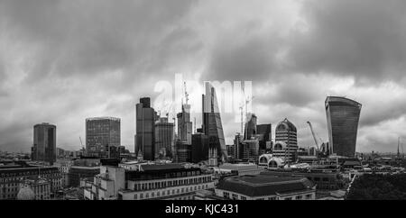City of London, London, UK, 26th October 2017.  Dark clouds gather over iconic modern buildings on the skyline of the financial and insurance district Stock Photo