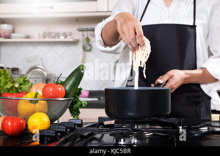 Chef Cutting cook Homemade makes dough fresh Pasta Stock Photo