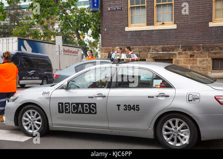 Taxi travelling along George street in The Rocks area of Sydney,Australia Stock Photo
