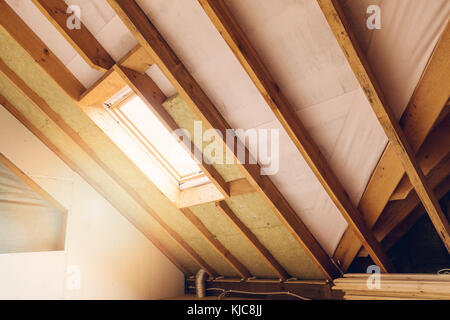 house attic under construction mansard wall insulation with rock wool Stock Photo