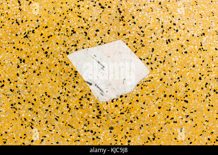 Abstract background of colorful polished stone wall and white freeform square on center wall with seamless pattern. Stock Photo