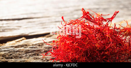 Dried saffron crocus on old wooden table, copy space Stock Photo