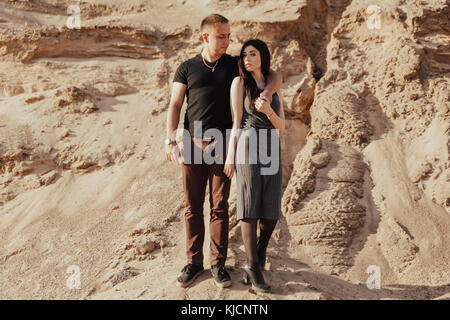 Middle Eastern couple standing in desert Stock Photo