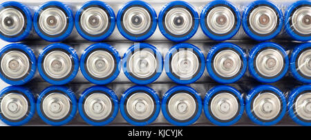 Lots of blue batteries, type AA, Packed in polyethylene film, on a white background, macro Stock Photo