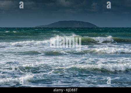 Waves crash onto Porth Neigwl beach, with Bardsey Island in the distance, near Abersoch, Llyn Penninsula, Gwynedd, Wales Stock Photo