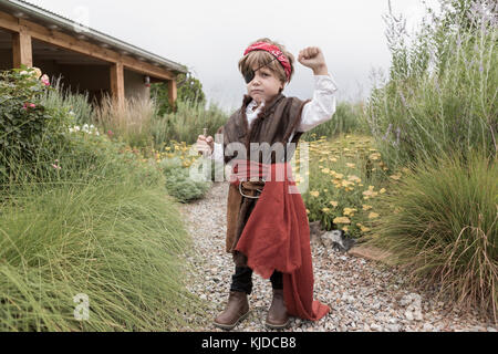 Caucasian boy wearing pirate costume holding knife Stock Photo