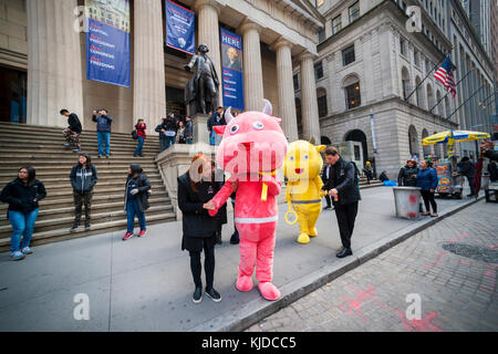 Actors dressed as mascots (with their handlers) parade and pose for photos in front of New York Stock Exchange for the first day of trading for the Chinese fintech firm Jianpu Technology initial public offering, on Thursday, November 16, 2017. Jianpu charges fees for its loan products and credit card recommendations. (© Richard B. Levine) Stock Photo