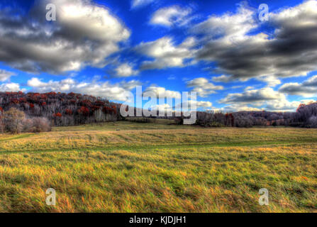 A landscape view of Indian Lake Park in Wisconsin, with fast-moving clouds over fields. Stock Photo
