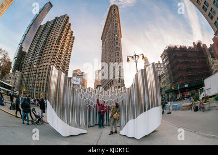 Visitors to Flatiron Plaza in New York on Tuesday, November 21, 2017 interact with 'Flatiron Reflection' designed by the design firm Future Expansion. The Christmas installation is the centerpiece of the Flatiron 23rd Street Partnership's  holiday programming.  (© Richard B. Levine) Stock Photo