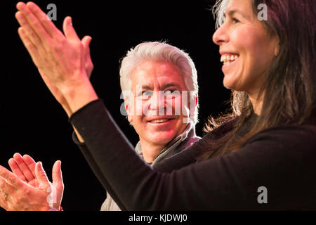 Hispanic man and woman clapping hands Stock Photo