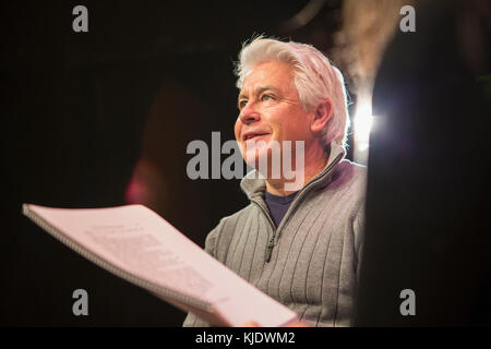 Hispanic man and woman reading scripts in theater Stock Photo