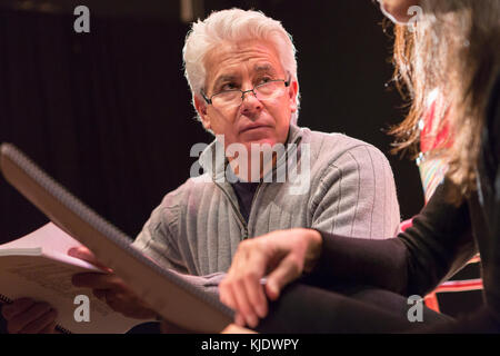 Hispanic man and woman reading scripts in theater Stock Photo