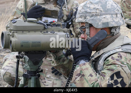 A Soldier with 1-14th Cavalry uses a Laser Designator Rangefinder to determine if artillery destroyed targets during a Joint Capabilities Integration Exercise Nov. 14, 2017, at Yakima Training Center, Washington. This was part of Operation Argos, a training exercise that included company combined arms live fire exercises, a sustainer gunnery and a joint capabilities integration exercise. (U.S. Army photo by Staff Sgt. Samuel Northrup) Stock Photo