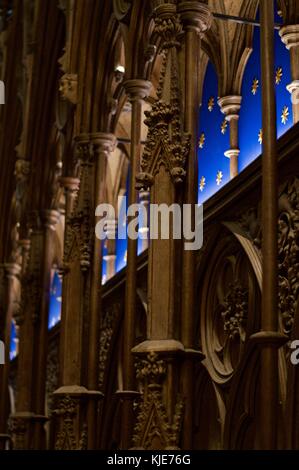 Choir stalls in Winchester Cathedral with blue lining studded with gold stars, UK Stock Photo