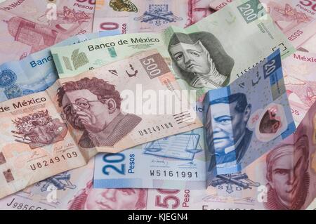 Bills of 20, 200 and 500 mexican pesos seem to be sad, while the one of 50 seems to be angry. Stock Photo